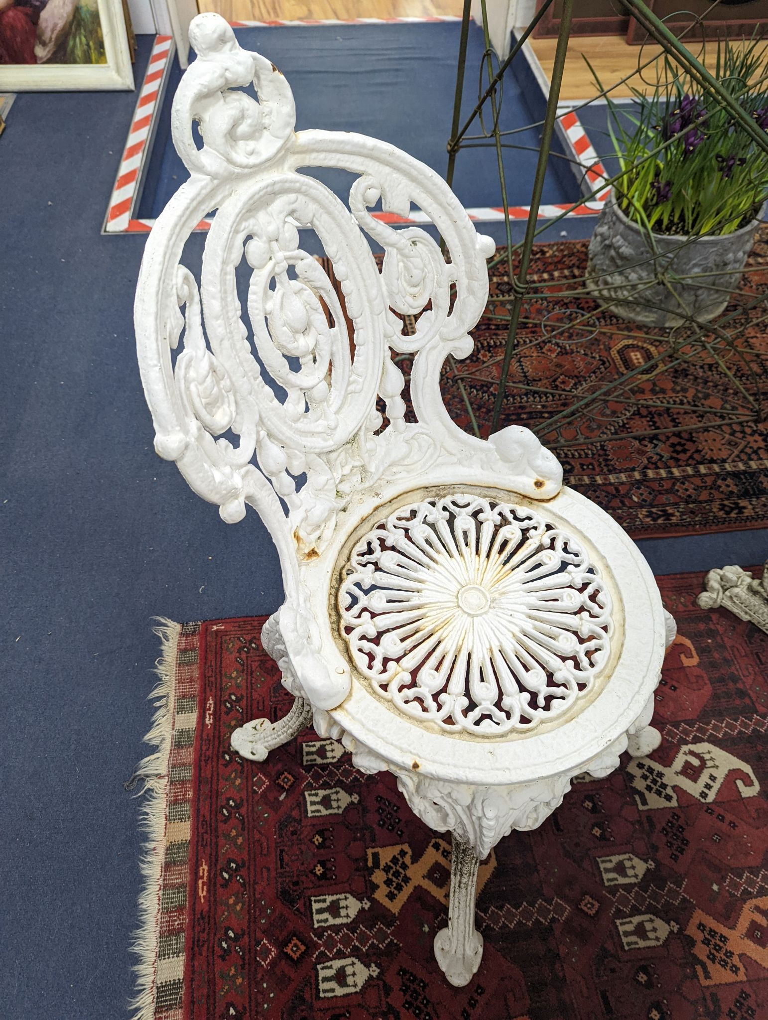 A Victorian Coalbrookdale style painted cast iron garden table, diameter 58cm, height 70cm and pair of chairs